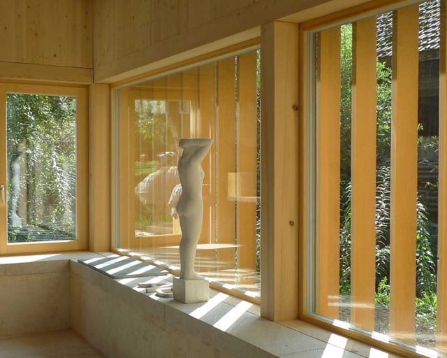 Innenausbau mit Massivholz, grossen Fenstern und hellen Holzoberflächen